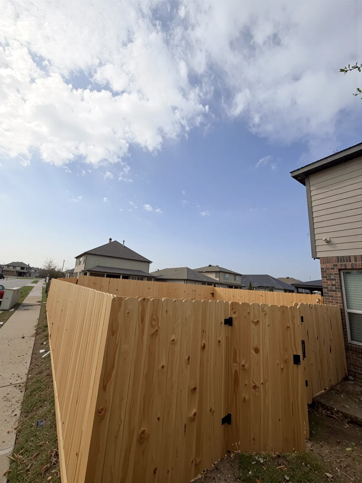 Freshly installed wood privacy fence on a corner lot in Houston, TX