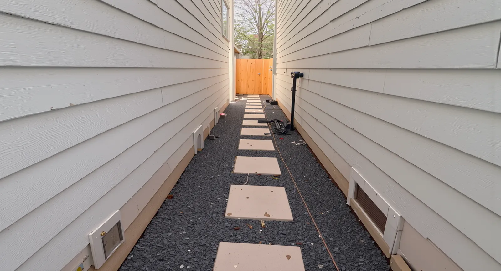 Side yard walkway with stepping stones and gravel built by New Green Landscaping in Houston