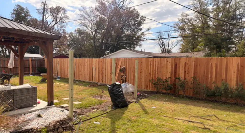 New wooden backyard fence installation